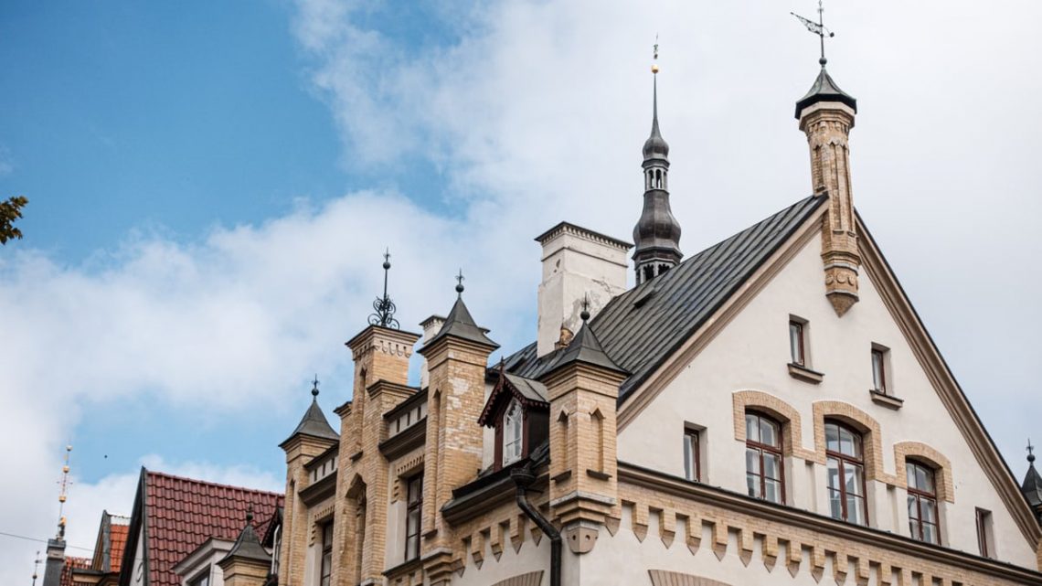 A striking example of Gothic architecture with ornate spires against a clear blue sky.