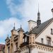 A striking example of Gothic architecture with ornate spires against a clear blue sky.